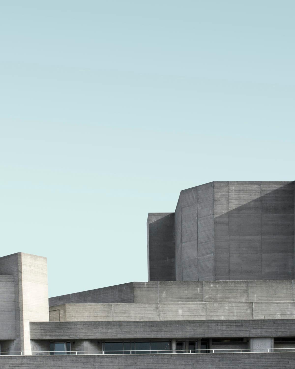 A concrete building in stepped volumes, held against an open sky.